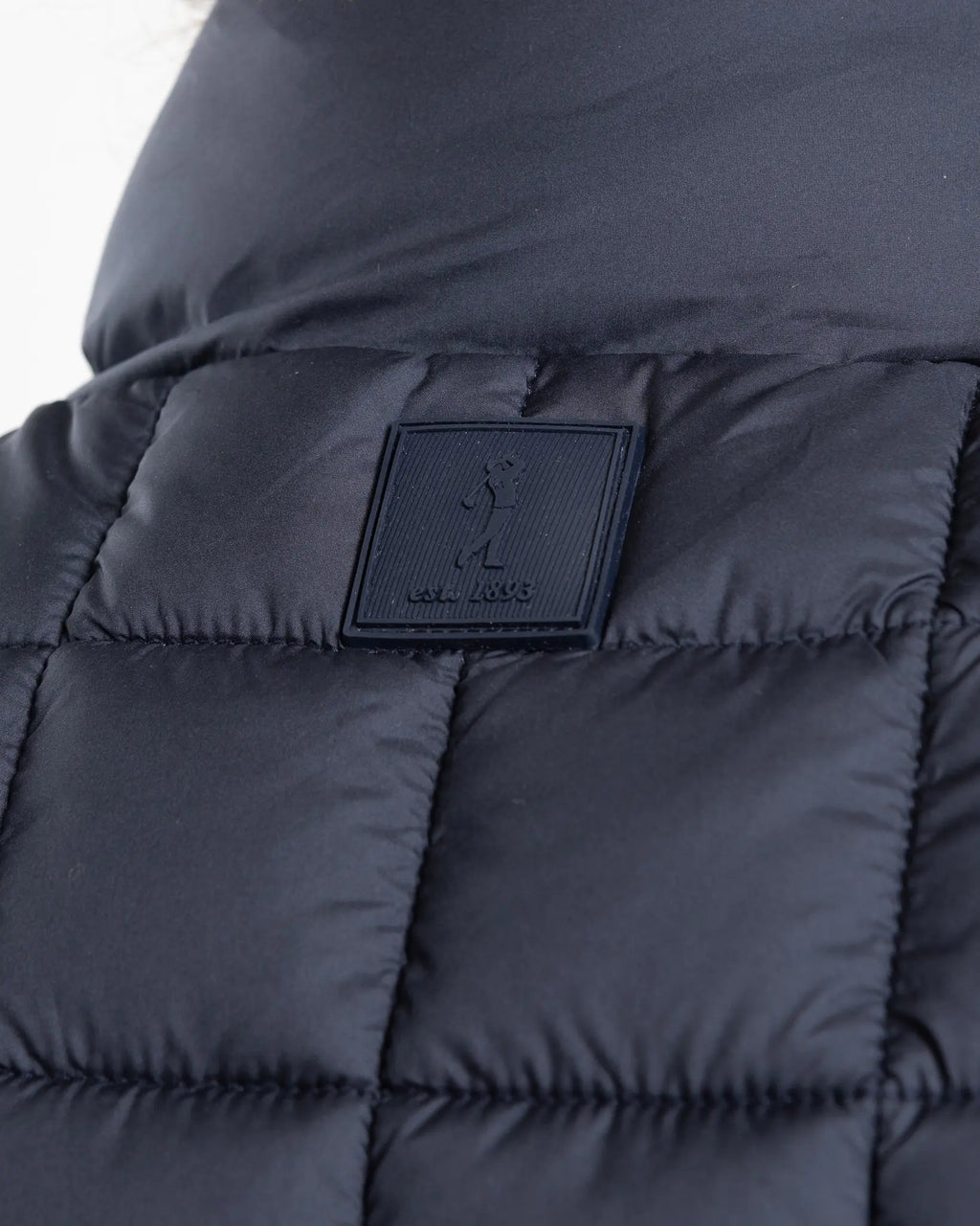 A clean, no-nonsense gilet built for layering. The box-quilt construction gives it structure and warmth, while the streamlined full-zip closure and high stand collar block the wind without adding bulk. Two side slip pockets sit flush with the quilting — functional without interrupting the clean lines.