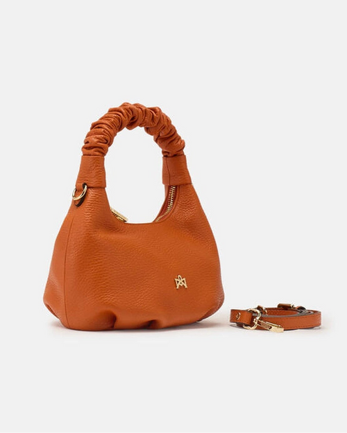 Description
Small but full of character, the mini hobo from the Chop line is the accessory that adds a touch of playful femininity to any outfit. Its soft design and ruched shoulder strap express a relaxed elegance, while the artisanal quality of the materials brings a sophisticated touch. Perfect for evenings out or casual weekends, it's a bag that surprises with its lightness and authentic style.

Composition
Suede is made from the lower part of the leather, which is softer and more flexible than the oute