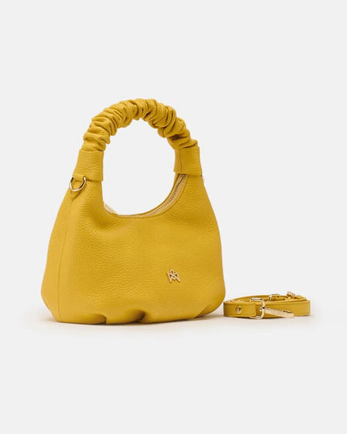 Description
Small but full of character, the mini hobo from the Chop line is the accessory that adds a touch of playful femininity to any outfit. Its soft design and ruched shoulder strap express a relaxed elegance, while the artisanal quality of the materials brings a sophisticated touch. Perfect for evenings out or casual weekends, it's a bag that surprises with its lightness and authentic style.

Composition
Suede is made from the lower part of the leather, which is softer and more flexible than the oute