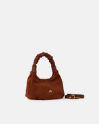 Description
Small but full of character, the mini hobo from the Chop line is the accessory that adds a touch of playful femininity to any outfit. Its soft design and ruched shoulder strap express a relaxed elegance, while the artisanal quality of the materials brings a sophisticated touch. Perfect for evenings out or casual weekends, it's a bag that surprises with its lightness and authentic style.

Composition
Suede is made from the lower part of the leather, which is softer and more flexible than the oute