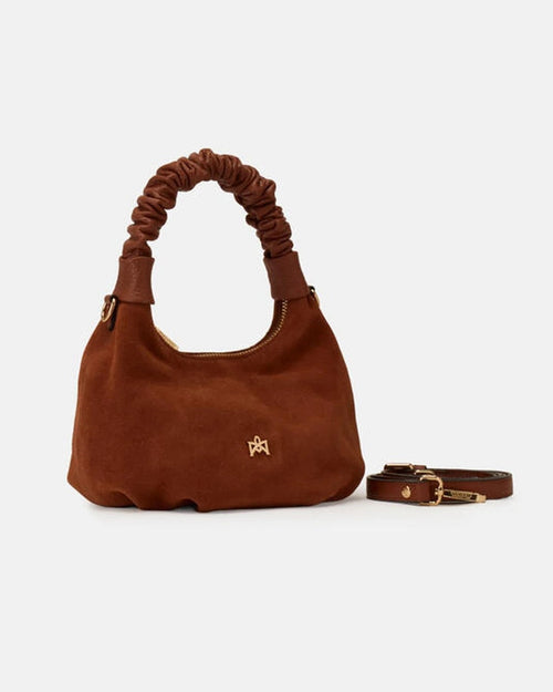 Description
Small but full of character, the mini hobo from the Chop line is the accessory that adds a touch of playful femininity to any outfit. Its soft design and ruched shoulder strap express a relaxed elegance, while the artisanal quality of the materials brings a sophisticated touch. Perfect for evenings out or casual weekends, it's a bag that surprises with its lightness and authentic style.

Composition
Suede is made from the lower part of the leather, which is softer and more flexible than the oute