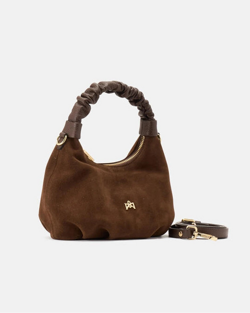 Description
Small but full of character, the mini hobo from the Chop line is the accessory that adds a touch of playful femininity to any outfit. Its soft design and ruched shoulder strap express a relaxed elegance, while the artisanal quality of the materials brings a sophisticated touch. Perfect for evenings out or casual weekends, it's a bag that surprises with its lightness and authentic style.

Composition
Suede is made from the lower part of the leather, which is softer and more flexible than the oute