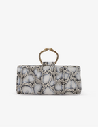 Clutch in precious snake leather with rounding rigid body and removable leather crossbody.Brass bracelet, iconic accessory of the Tramontano archive handcrafted.Top closure with double magnets. Microfiber lining. Accessories in gold finish. Material: Snake ElapheDimensions: 31x12x8 cm