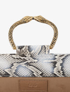Clutch in precious snake leather with rounding rigid body and removable leather crossbody.Brass bracelet, iconic accessory of the Tramontano archive handcrafted.Top closure with double magnets. Microfiber lining. Accessories in gold finish. Material: Snake ElapheDimensions: 31x12x8 cm