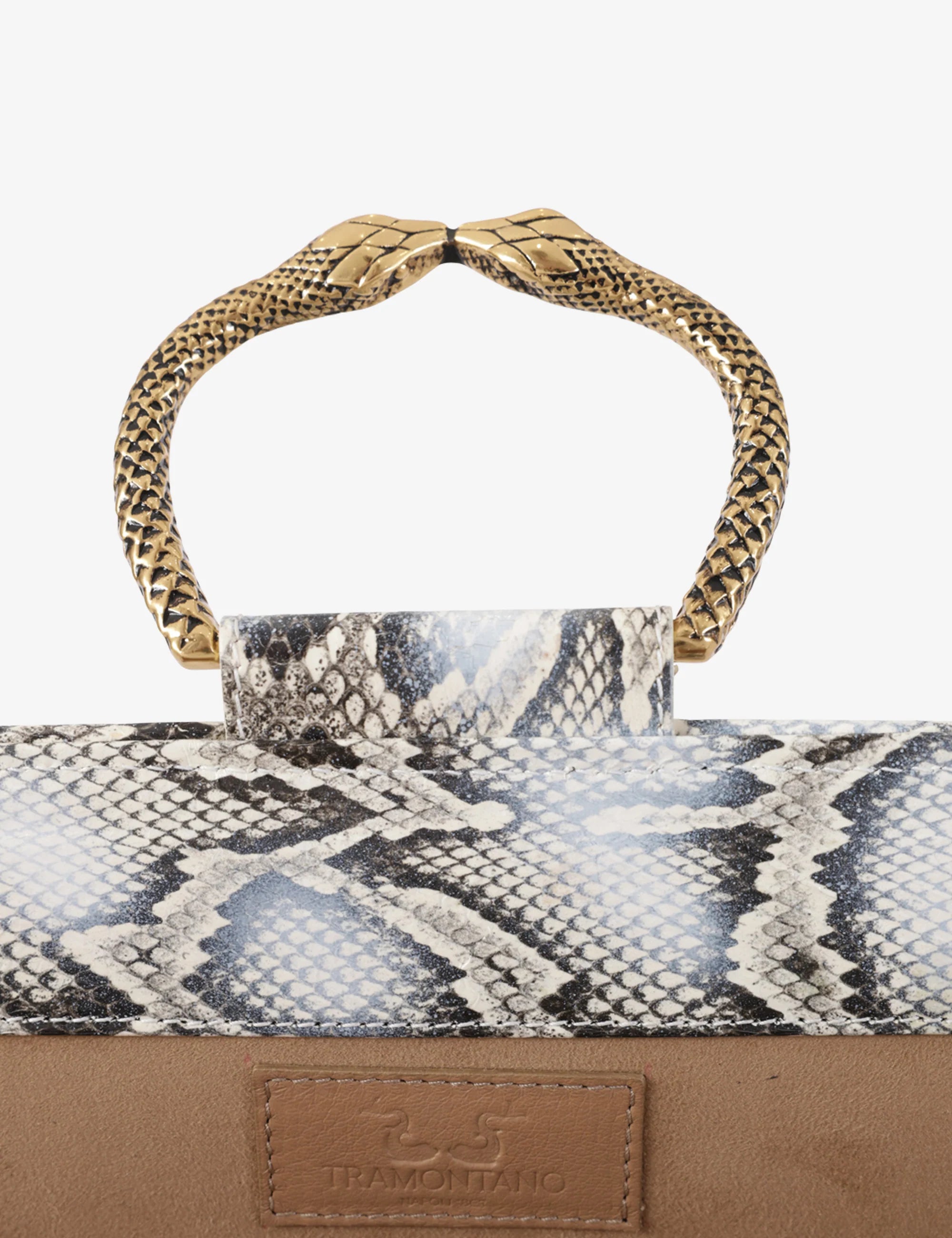Clutch in precious snake leather with rounding rigid body and removable leather crossbody.Brass bracelet, iconic accessory of the Tramontano archive handcrafted.Top closure with double magnets. Microfiber lining. Accessories in gold finish. Material: Snake ElapheDimensions: 31x12x8 cm