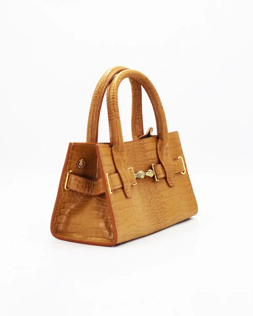 Mini bag made of precious lambskin with a crumpled effect and a delicate glossy finish, with double handles and a removable leather shoulder strap.


The bag is embellished on both the front and back with the iconic Tramontano archive accessory, in handcrafted gold-plated brass.
Top closure with magnet.

Microfiber lining.&nbsp;Gold-finish accessories.

Material:&nbsp;Moon lamb
Dimensions:&nbsp;25x13x10.5 cm