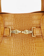Mini bag made of precious lambskin with a crumpled effect and a delicate glossy finish, with double handles and a removable leather shoulder strap.


The bag is embellished on both the front and back with the iconic Tramontano archive accessory, in handcrafted gold-plated brass.
Top closure with magnet.

Microfiber lining.&nbsp;Gold-finish accessories.

Material:&nbsp;Moon lamb
Dimensions:&nbsp;25x13x10.5 cm