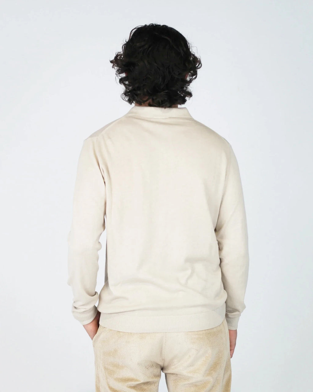 The Fiftieth Men's Cotton Long Sleeve Polo in Beige is a refined everyday essential crafted from 100% cotton. Featuring a classic polo collar and a relaxed regular fit, this versatile piece layers effortlessly or stands alone for a clean, polished look.