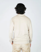 The Fiftieth Men's Cotton Long Sleeve Polo in Beige is a refined everyday essential crafted from 100% cotton. Featuring a classic polo collar and a relaxed regular fit, this versatile piece layers effortlessly or stands alone for a clean, polished look.