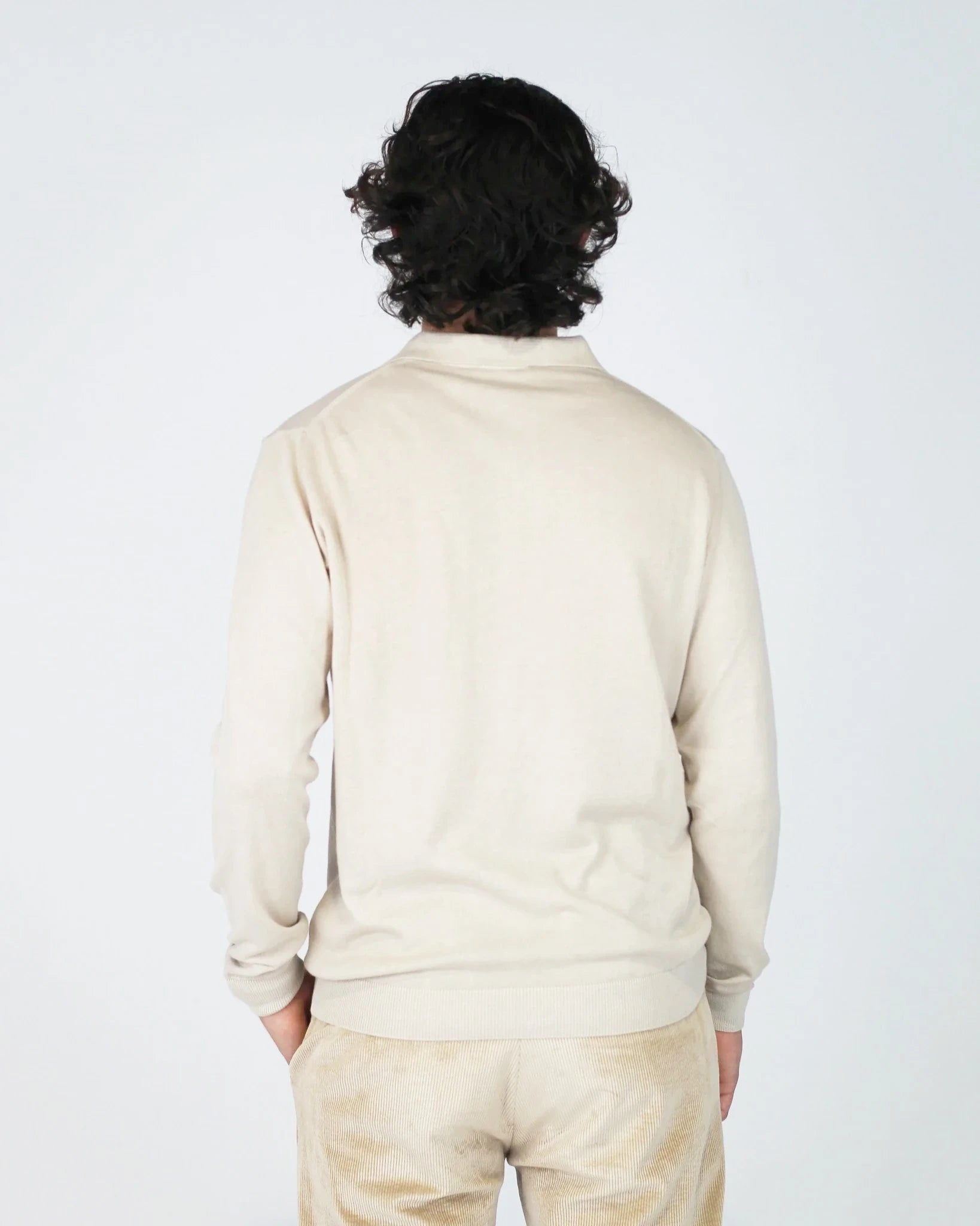 The Fiftieth Men's Cotton Long Sleeve Polo in Beige is a refined everyday essential crafted from 100% cotton. Featuring a classic polo collar and a relaxed regular fit, this versatile piece layers effortlessly or stands alone for a clean, polished look.