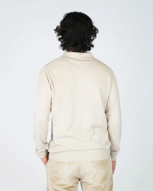 The Fiftieth Men's Cotton Long Sleeve Polo in Beige is a refined everyday essential crafted from 100% cotton. Featuring a classic polo collar and a relaxed regular fit, this versatile piece layers effortlessly or stands alone for a clean, polished look.