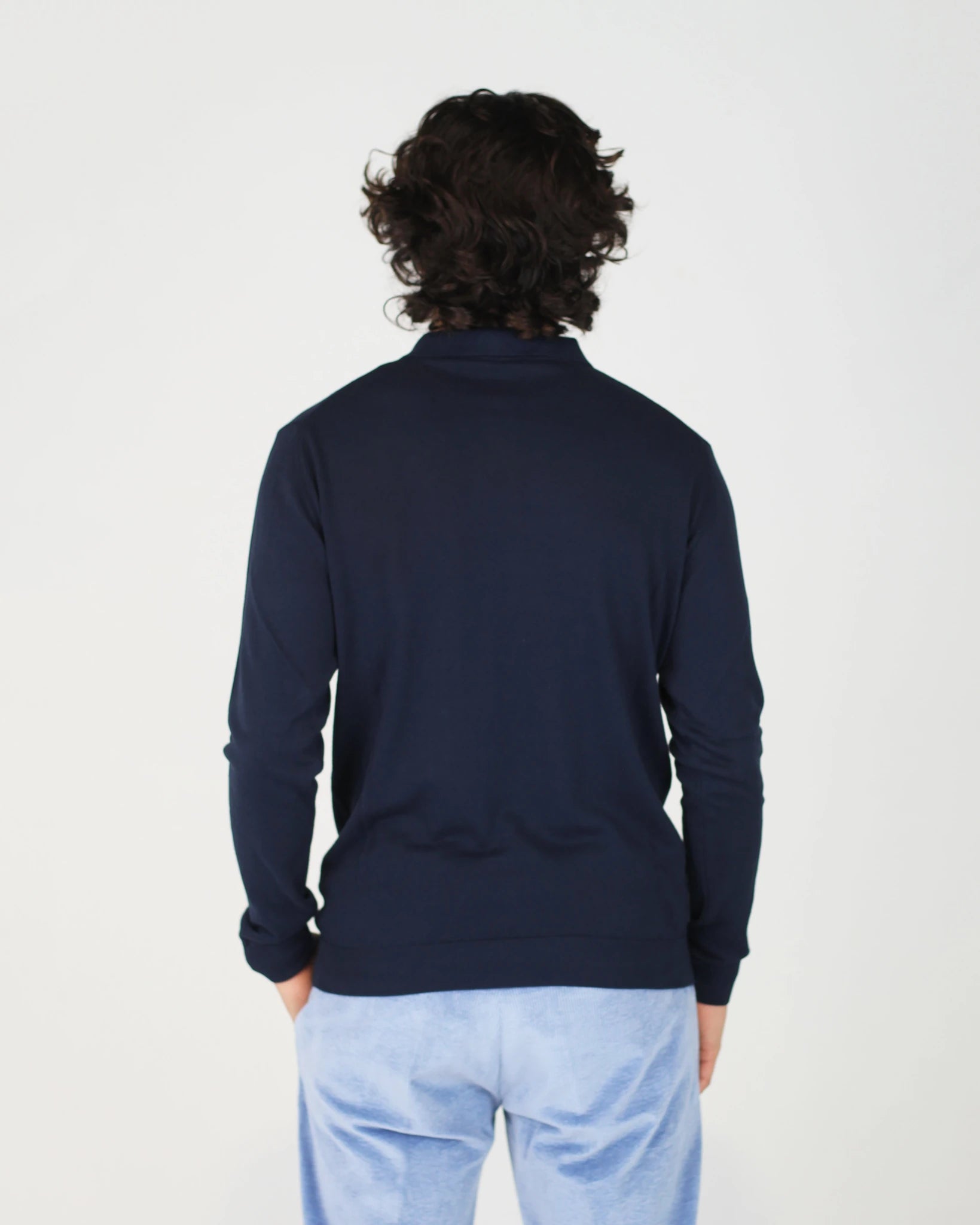 The Fiftieth Men's Cotton Long Sleeve Polo in Navy Blue is a refined everyday essential crafted from 100% cotton. Featuring a classic polo collar and a relaxed regular fit, this versatile piece layers effortlessly or stands alone for a clean, polished look.