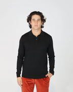 The Fiftieth Men's Cotton Long Sleeve Polo in Black is a refined everyday essential crafted from 100% cotton. Featuring a classic polo collar and a relaxed regular fit, this versatile piece layers effortlessly or stands alone for a clean, polished look.