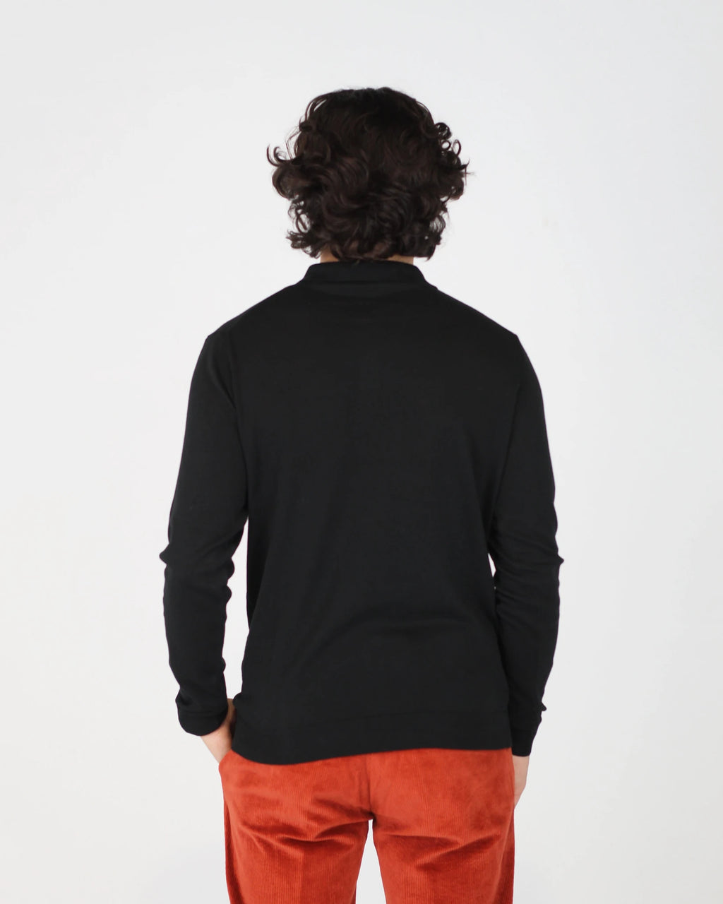 The Fiftieth Men's Cotton Long Sleeve Polo in Black is a refined everyday essential crafted from 100% cotton. Featuring a classic polo collar and a relaxed regular fit, this versatile piece layers effortlessly or stands alone for a clean, polished look.