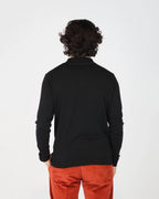 The Fiftieth Men's Cotton Long Sleeve Polo in Black is a refined everyday essential crafted from 100% cotton. Featuring a classic polo collar and a relaxed regular fit, this versatile piece layers effortlessly or stands alone for a clean, polished look.