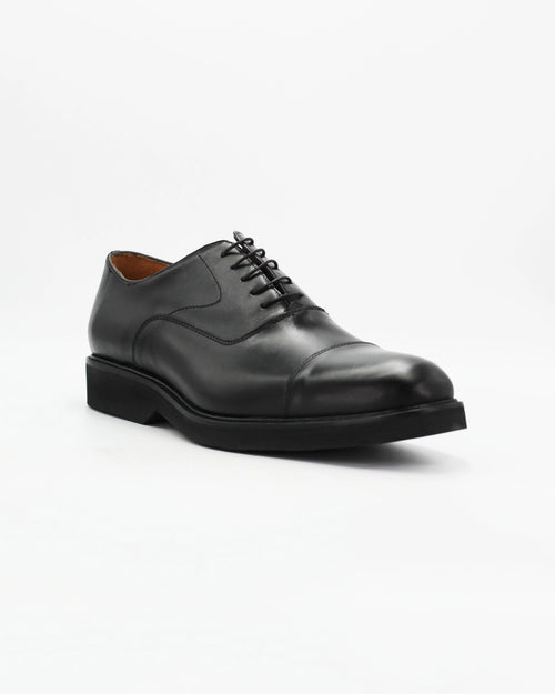 The Men's Cap-Toe Oxford in Leather Black is the definitive dress shoe. Clean, sharp, and timeless — the closed lacing system and structured cap toe make it the most formal lace-up in any wardrobe.

The high-shine black leather and solid black sole give it a sleek, polished finish that pairs perfectly with a suit or smart trousers.&nbsp;
Style: Oxford
Colour: Nero
Material: Calf Leather
Sole Material: Rubber

Code: MER6649

Made in Italy