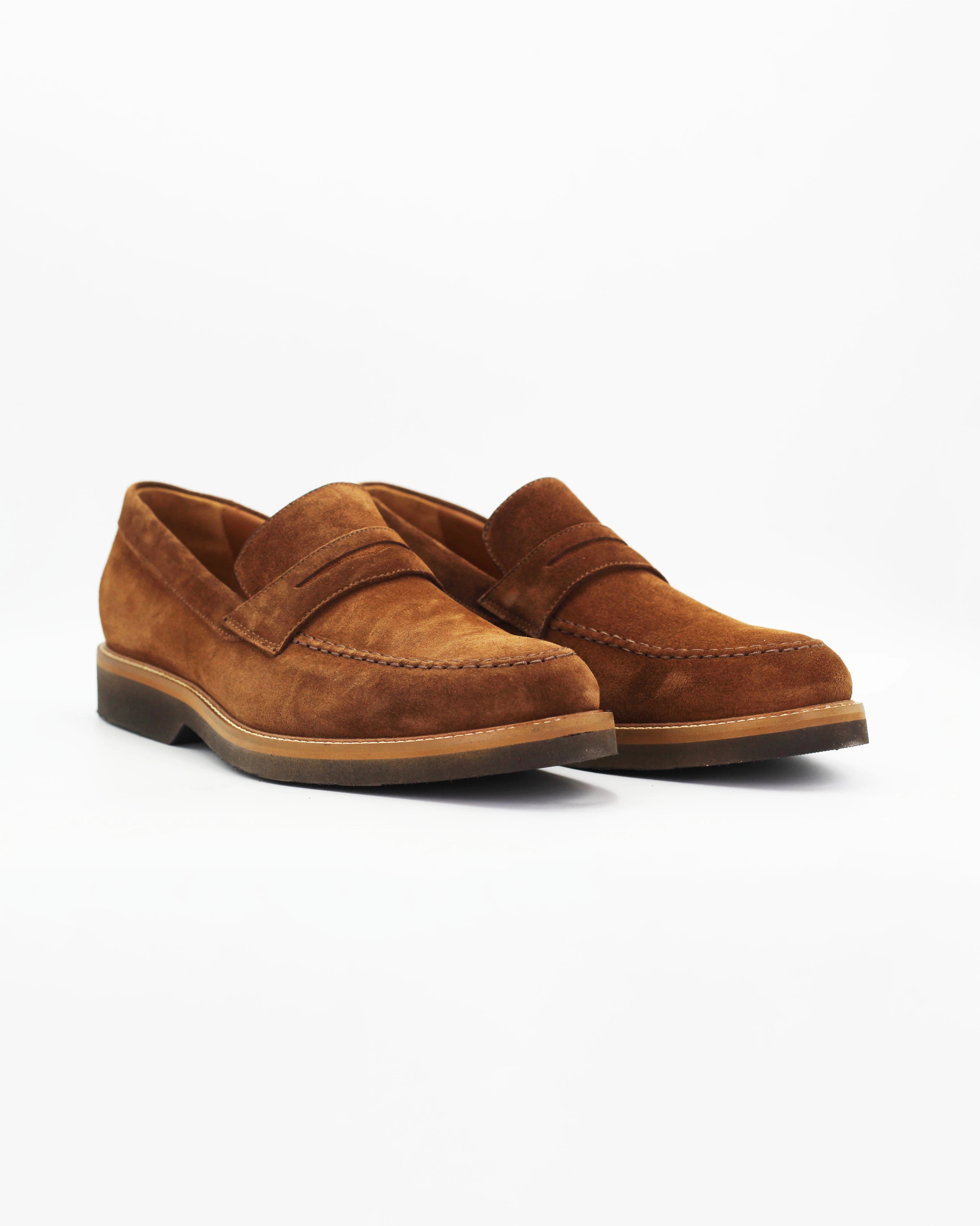 The Men's Penny Moccasin in Suede Brown is a clean, unfussy slip-on that never goes out of style. The rich dark brown suede upper and signature penny strap keep the look classic, while the contrast sole adds a refined finishing touch.

Effortlessly versatile — wear it with tailored trousers, chinos, or casual denim.&nbsp;
Style: Moccasin
Feature: Penny Feature
Colour: Marrone Tan
Material: Calf Leather Suede
Sole Material: Rubber

Code: MER8395

Made in Italy