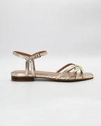 Shop the PATTY14 flat woven sandal in gold calf leather. Italian-made with a woven strap detail, adjustable ankle strap, and rubber sole. Effortless metallic elegance.