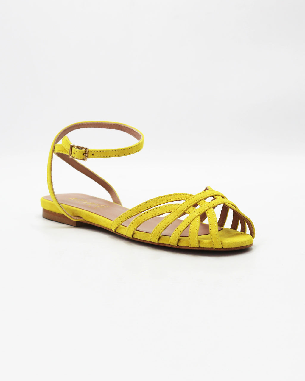 Shop the CIRA5 flat lattice sandal in lime suede calf leather. Italian-made with a woven strap detail, adjustable ankle strap, and rubber sole. Vibrant summer elegance.