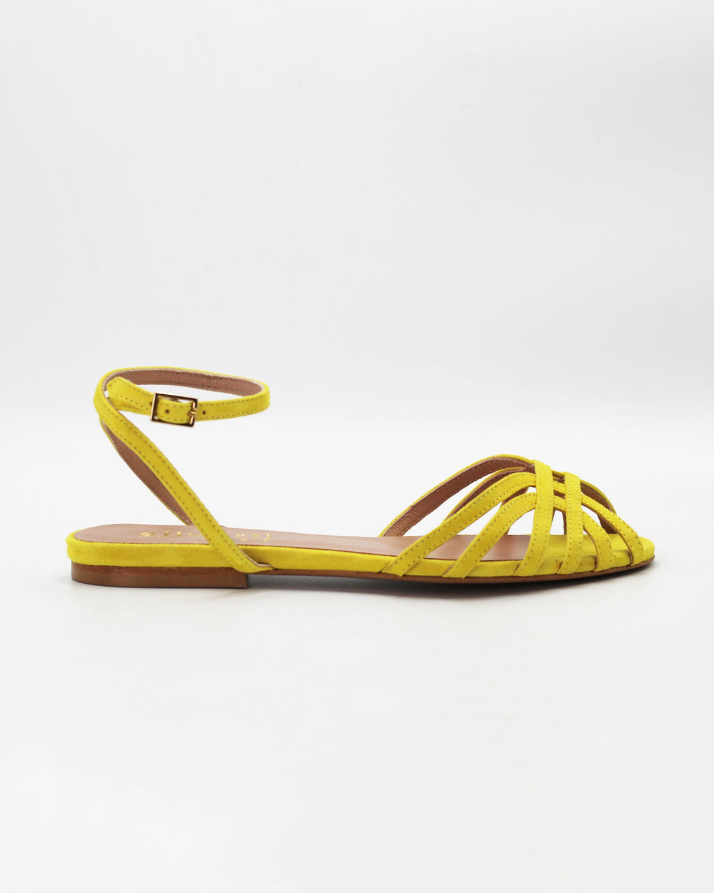 Shop the CIRA5 flat lattice sandal in lime suede calf leather. Italian-made with a woven strap detail, adjustable ankle strap, and rubber sole. Vibrant summer elegance.
