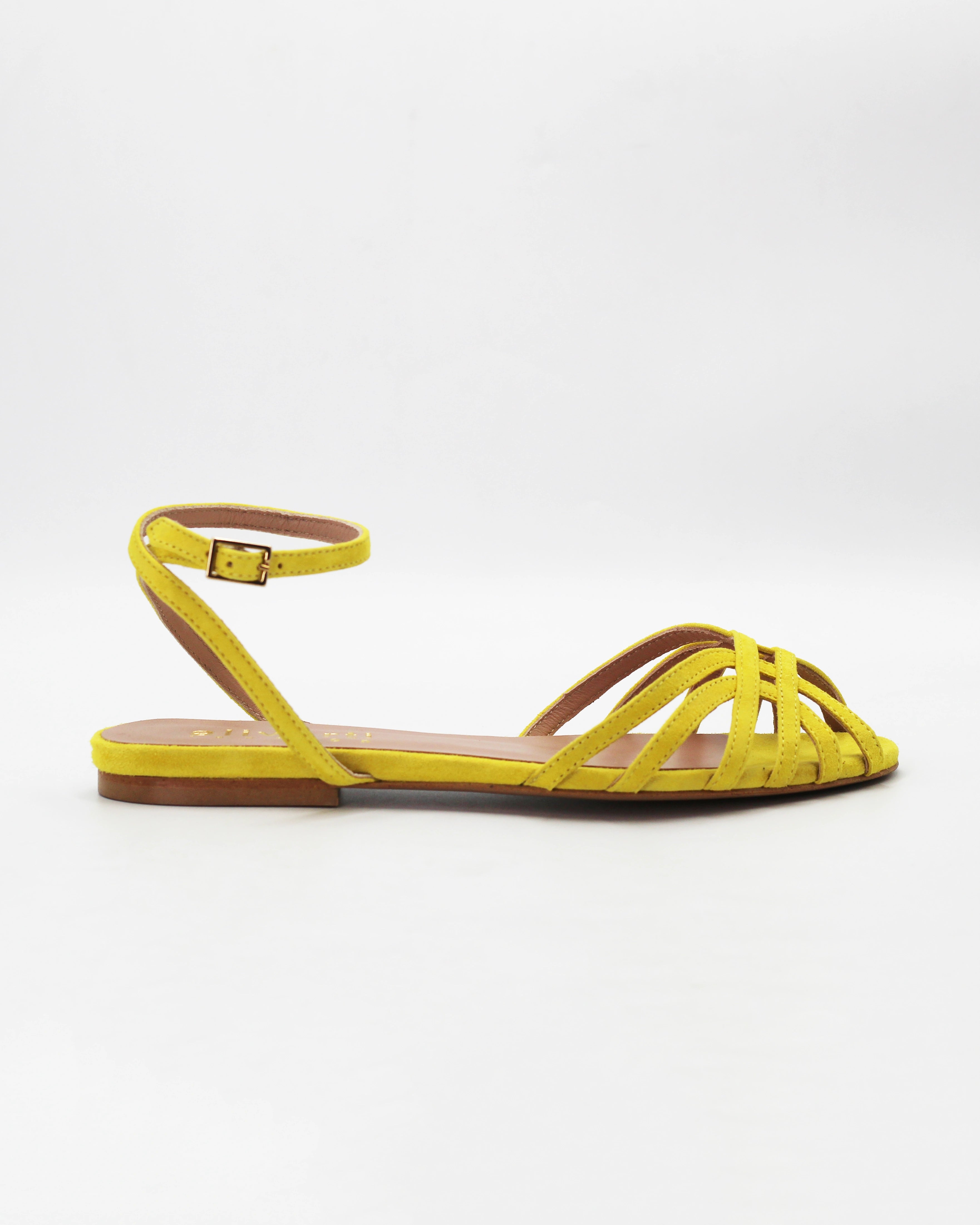 Shop the CIRA5 flat lattice sandal in lime suede calf leather. Italian-made with a woven strap detail, adjustable ankle strap, and rubber sole. Vibrant summer elegance.