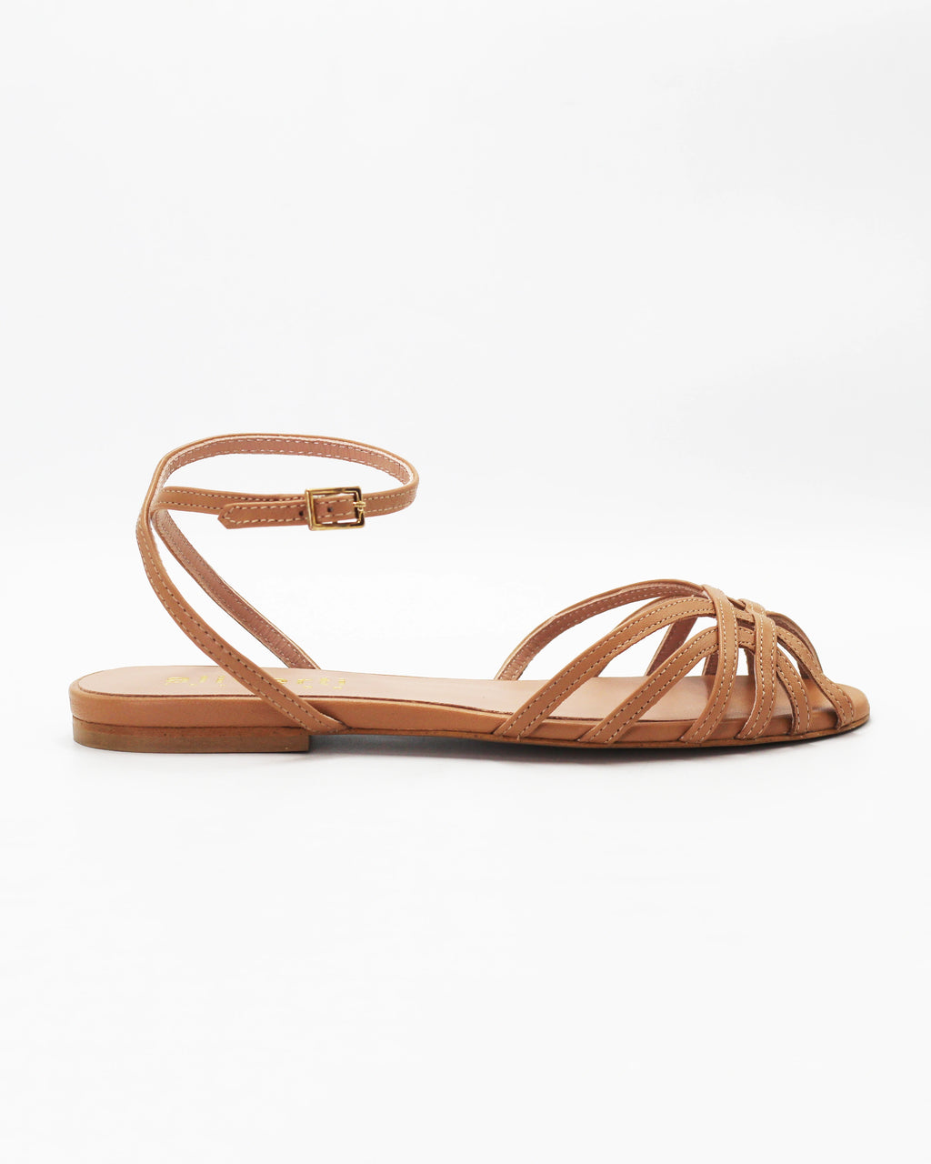 Shop the CIRA5 flat lattice sandal in tan calf leather. Italian-made with a woven strap detail, adjustable ankle strap, and rubber sole. Understated summer elegance.