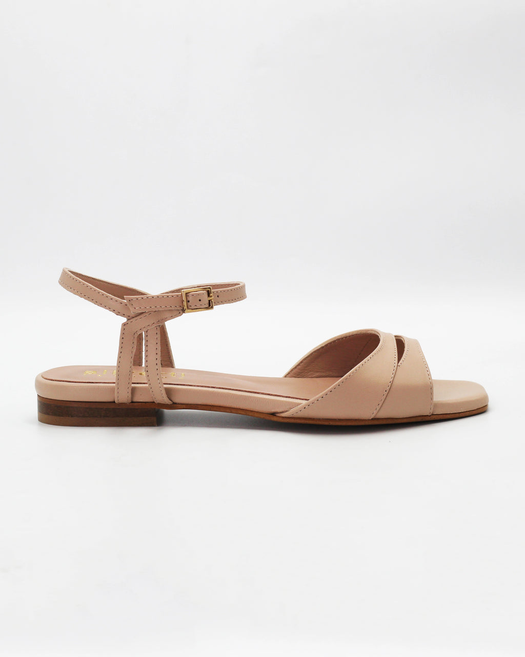 Shop the PATTY26 flat two-strap sandal in taupe calf leather. Italian-made with a crossover cut-out detail, adjustable ankle strap, and rubber sole. Understated summer elegance.