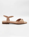 Shop the PATTY26 flat two-strap sandal in taupe calf leather. Italian-made with a crossover cut-out detail, adjustable ankle strap, and rubber sole. Understated summer elegance.