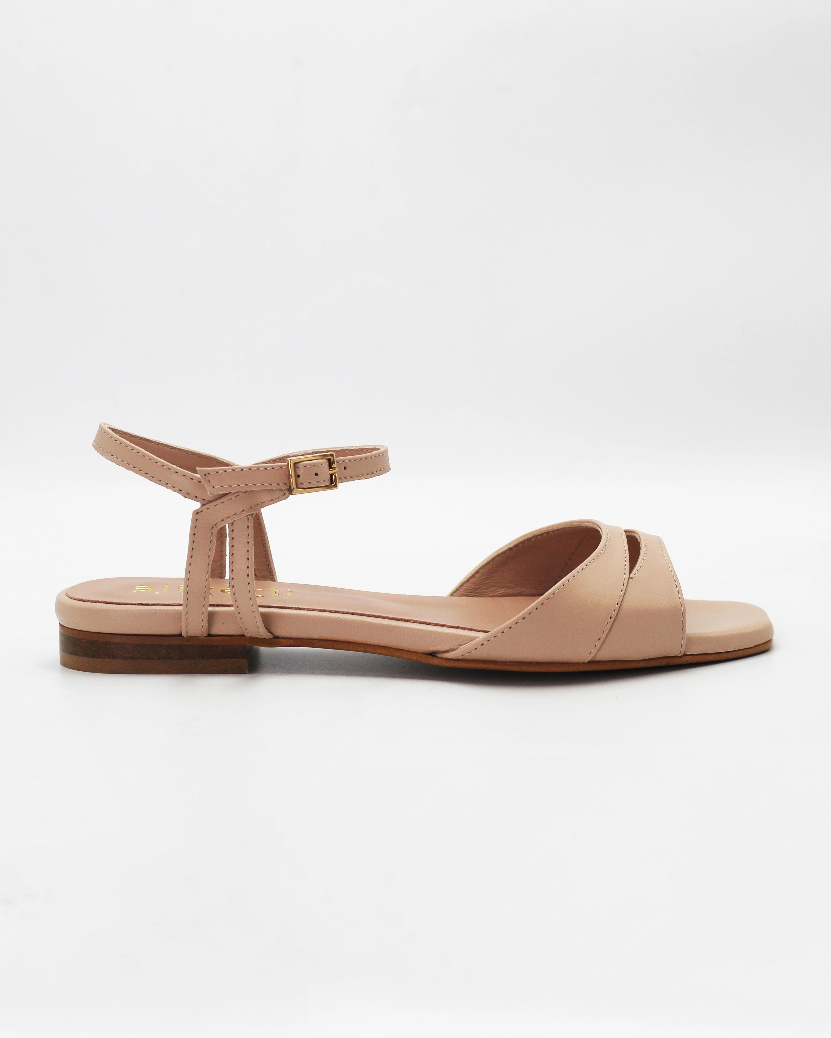 Shop the PATTY26 flat two-strap sandal in taupe calf leather. Italian-made with a crossover cut-out detail, adjustable ankle strap, and rubber sole. Understated summer elegance.