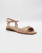 Shop the PATTY26 flat two-strap sandal in taupe calf leather. Italian-made with a crossover cut-out detail, adjustable ankle strap, and rubber sole. Understated summer elegance.