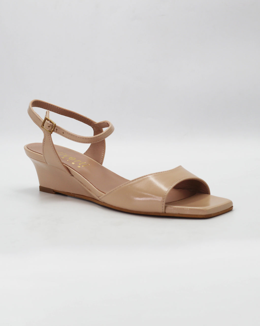 Chic beige wedge sandals in smooth calf leather with an adjustable ankle strap. Handcrafted in Italy with a durable rubber sole. Effortless warm-weather style.