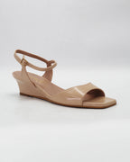 Chic beige wedge sandals in smooth calf leather with an adjustable ankle strap. Handcrafted in Italy with a durable rubber sole. Effortless warm-weather style.