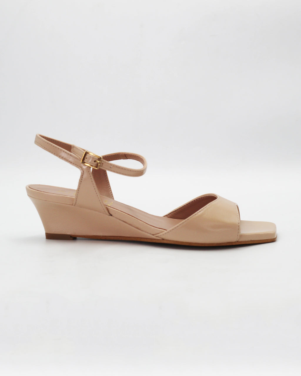 Chic beige wedge sandals in smooth calf leather with an adjustable ankle strap. Handcrafted in Italy with a durable rubber sole. Effortless warm-weather style.