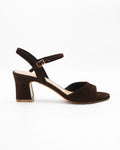 Shop the RIVOLI23 block heel sandal in dark brown suede calf leather. Italian-made with a cut-out crossover strap, adjustable ankle strap, and rubber sole. Elevated summer elegance.