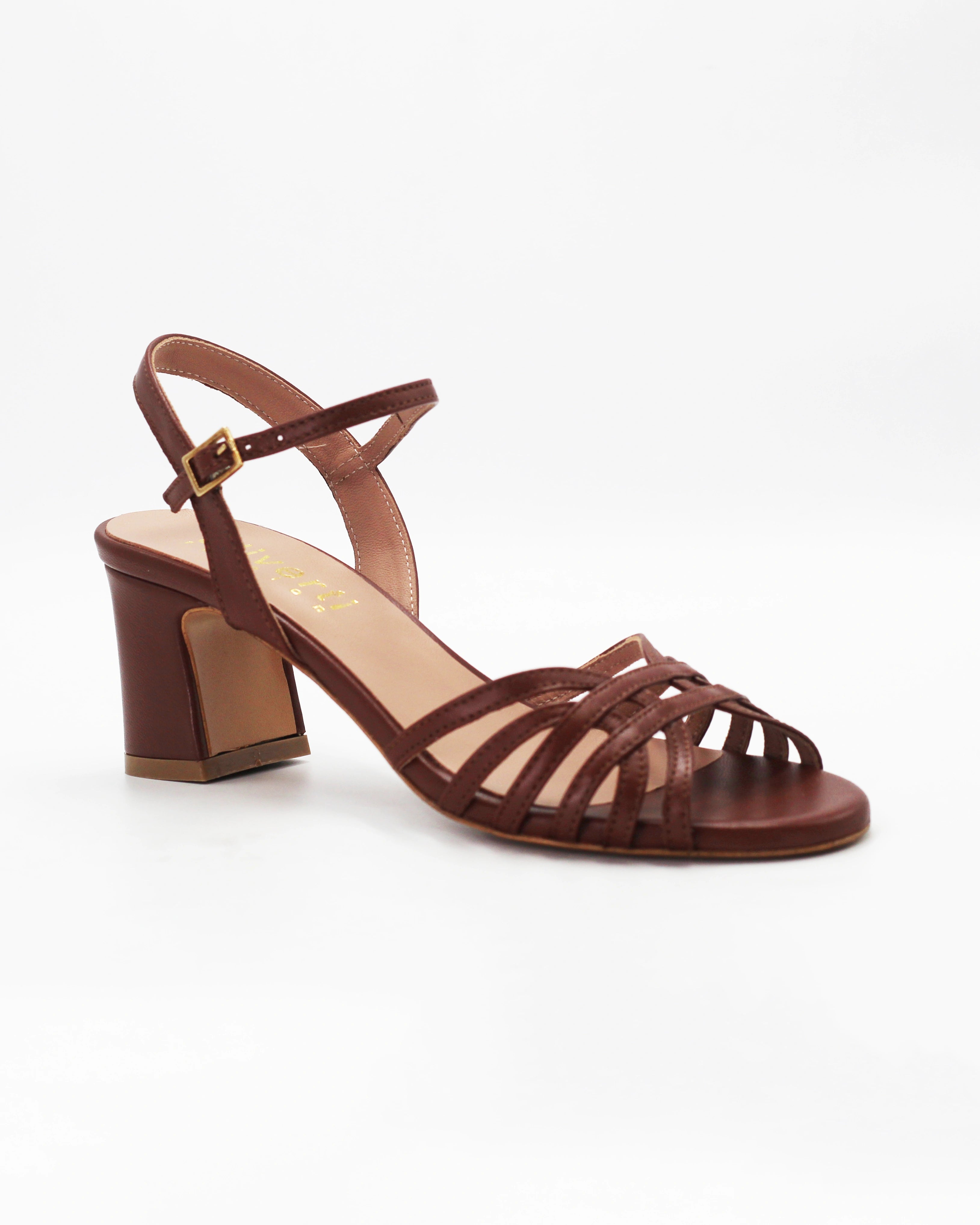 Shop the RIVOLI19 block heel sandal in brown calf leather. Italian-made with a woven strap detail, adjustable ankle strap, and rubber sole. Elevated summer elegance.