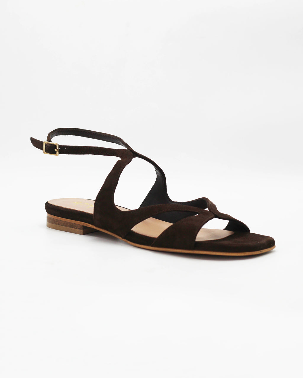 PATTY20 flat sandal in testa di moro suede with a sleek asymmetric toe strap and adjustable ankle strap. Handcrafted in Italy. Understated and easy.
