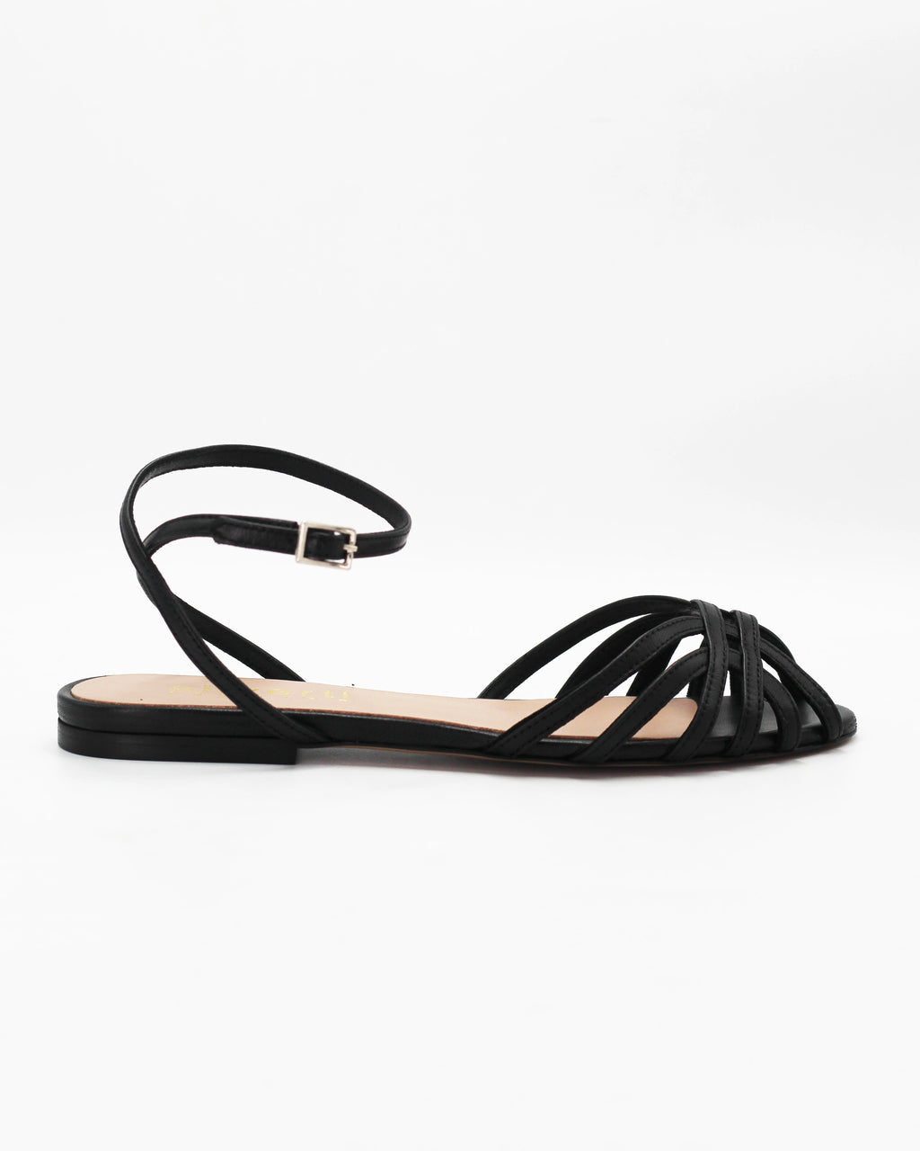 Shop the CIRA5 flat lattice sandal in black calf leather. Italian-made with a woven strap detail, adjustable ankle strap, and rubber sole. Classic summer elegance.