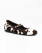 Shop the 6050 Mary Jane ballerina flat in brown cow-print calf hair. Italian-made with a buckle strap and rubber sole. Playful everyday elegance.