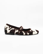 Shop the 6050 Mary Jane ballerina flat in brown cow-print calf hair. Italian-made with a buckle strap and rubber sole. Playful everyday elegance.