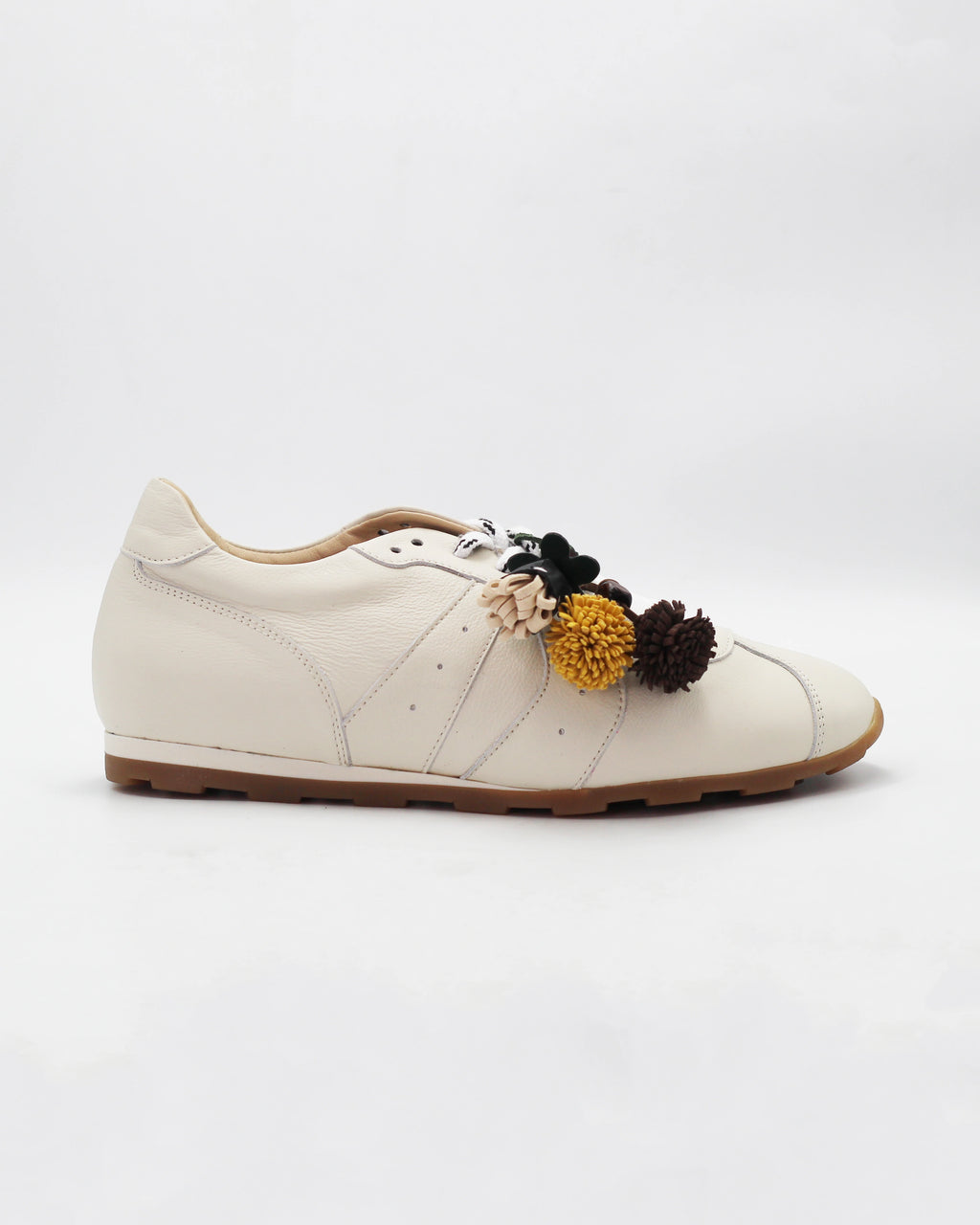 Shop the 6066 leather sneaker in cream calf leather. Italian-made with playful floral charm details and a rubber sole. Casual everyday elegance.