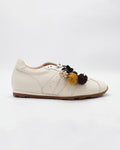 Shop the 6066 leather sneaker in cream calf leather. Italian-made with playful floral charm details and a rubber sole. Casual everyday elegance.