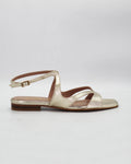 PATTY20 flat sandal in platino leather with a sleek asymmetric toe strap and adjustable ankle strap. Handcrafted in Italy. Understated and easy.