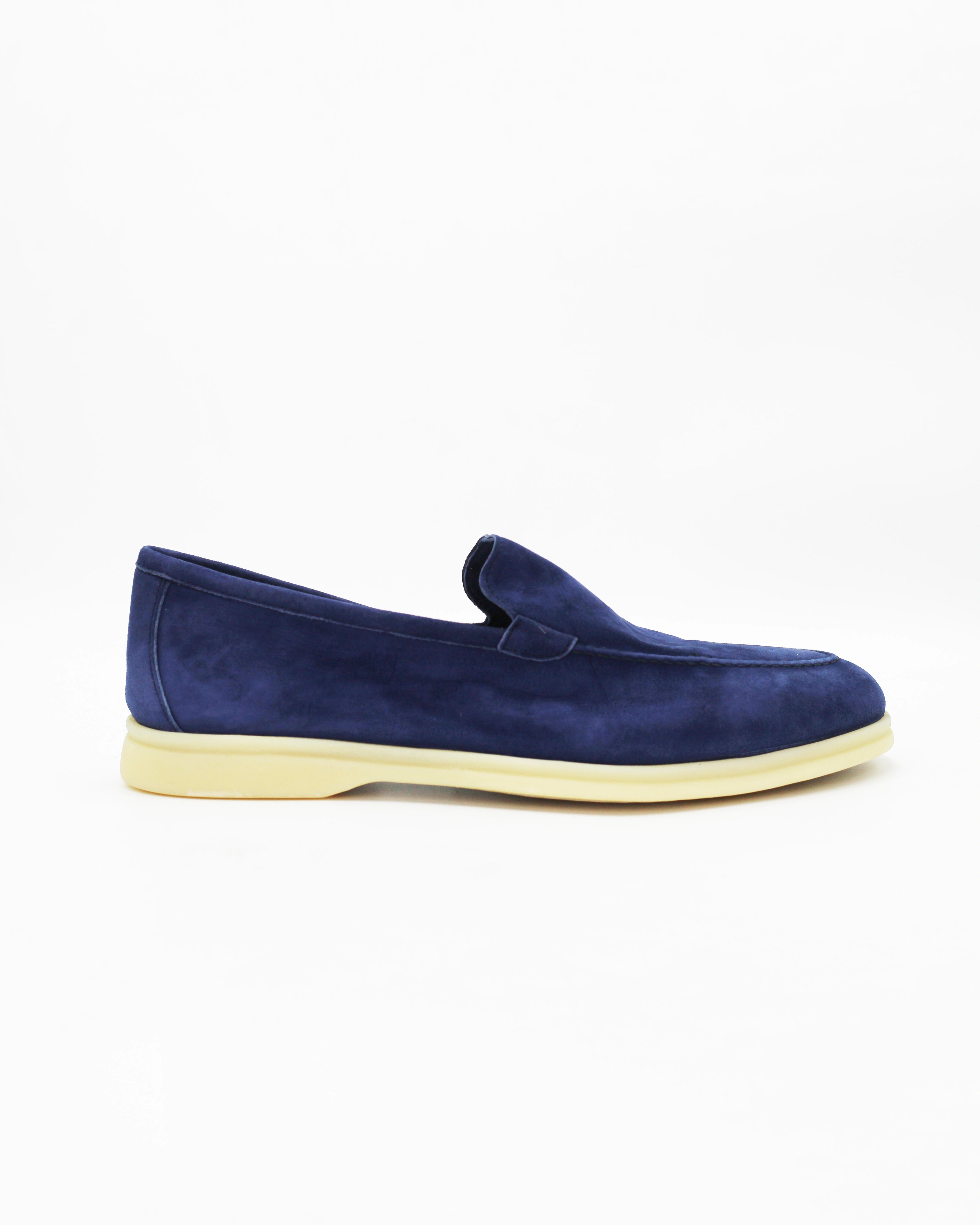 Shop the UO32017 slip-on loafer in blue suede calf leather. Italian-made with a soft unstructured silhouette and rubber sole. Refined everyday elegance.