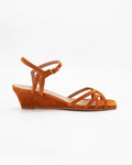 LYA8 wedge sandal in tangerine suede with delicate woven straps and an adjustable ankle strap. Handcrafted in Italy. Soft lift, all-day comfort.