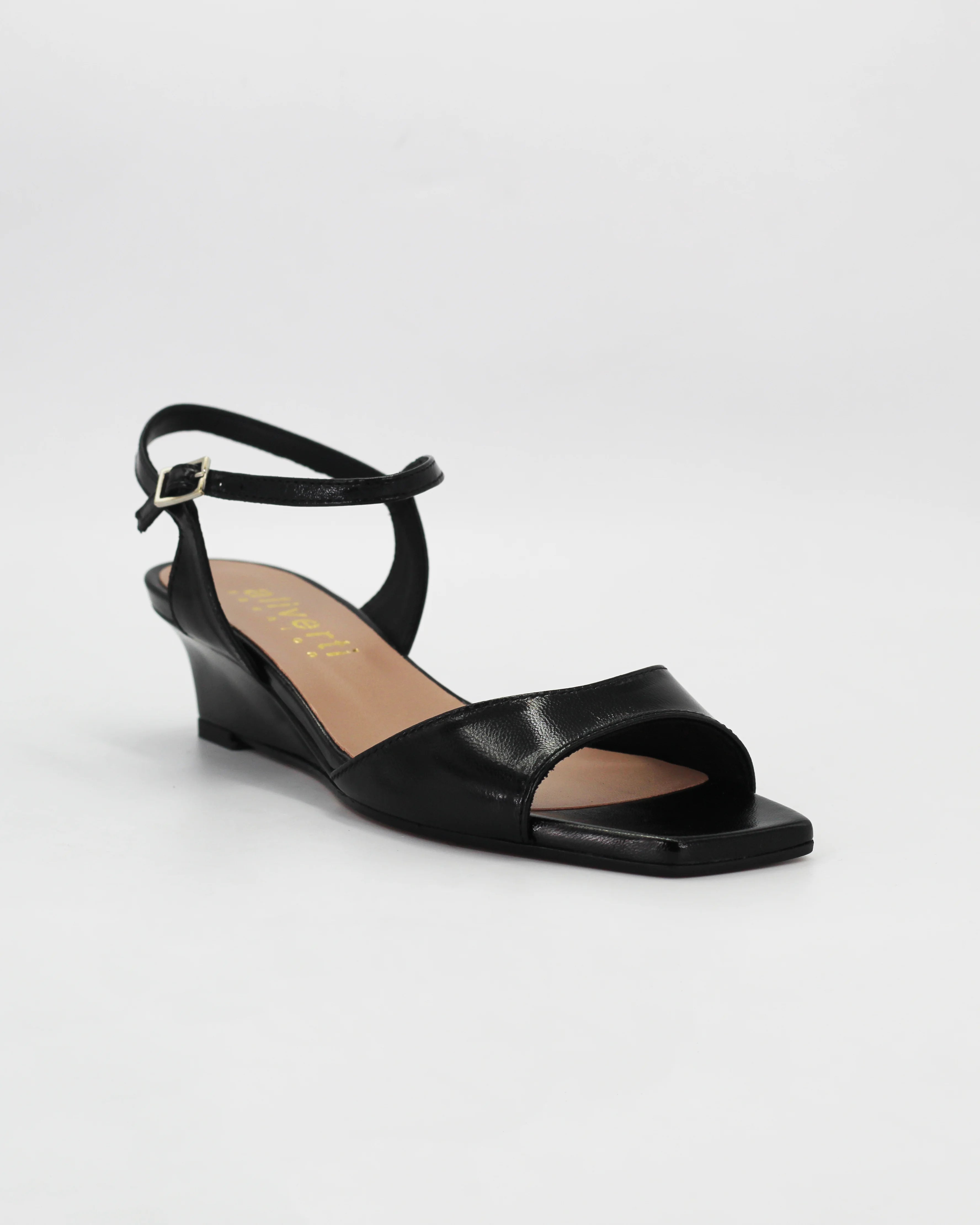 LYA3 low wedge sandal in nero calf leather with a smooth toe strap and adjustable ankle strap. Handcrafted in Italy. Effortless lift and comfort.