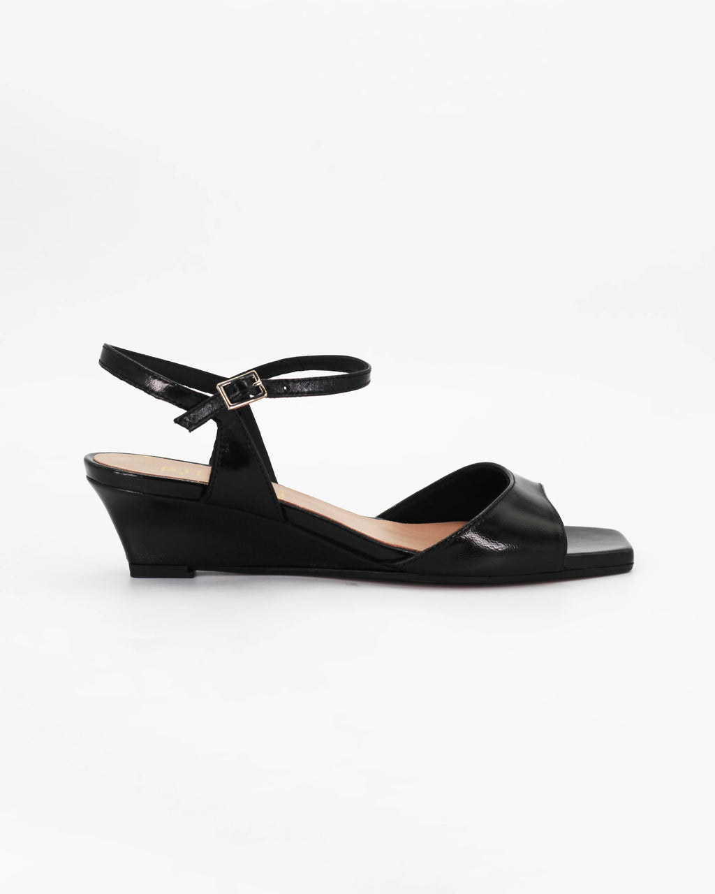 LYA3 low wedge sandal in nero calf leather with a smooth toe strap and adjustable ankle strap. Handcrafted in Italy. Effortless lift and comfort.