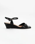 LYA3 low wedge sandal in nero calf leather with a smooth toe strap and adjustable ankle strap. Handcrafted in Italy. Effortless lift and comfort.