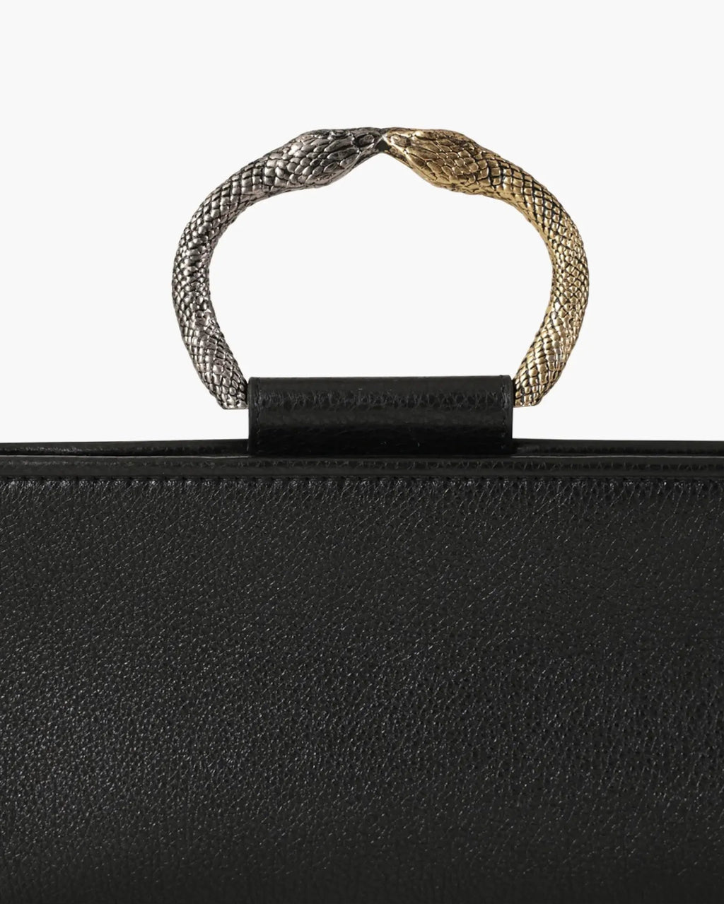 Laminated leather clutch with rounding rigid body and removable leather strail strap.Brass double-sided braceletDouble gold and silver color, iconic accessory of the Tramontano archive handcrafted. Top closure with double magnets. Microfiber lining. Accessories in silver finish. Material: shimmer calfDimensions: 31x12x8 cm
