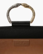 Laminated leather clutch with rounding rigid body and removable leather strail strap.Brass double-sided braceletDouble gold and silver color, iconic accessory of the Tramontano archive handcrafted. Top closure with double magnets. Microfiber lining. Accessories in silver finish. Material: shimmer calfDimensions: 31x12x8 cm