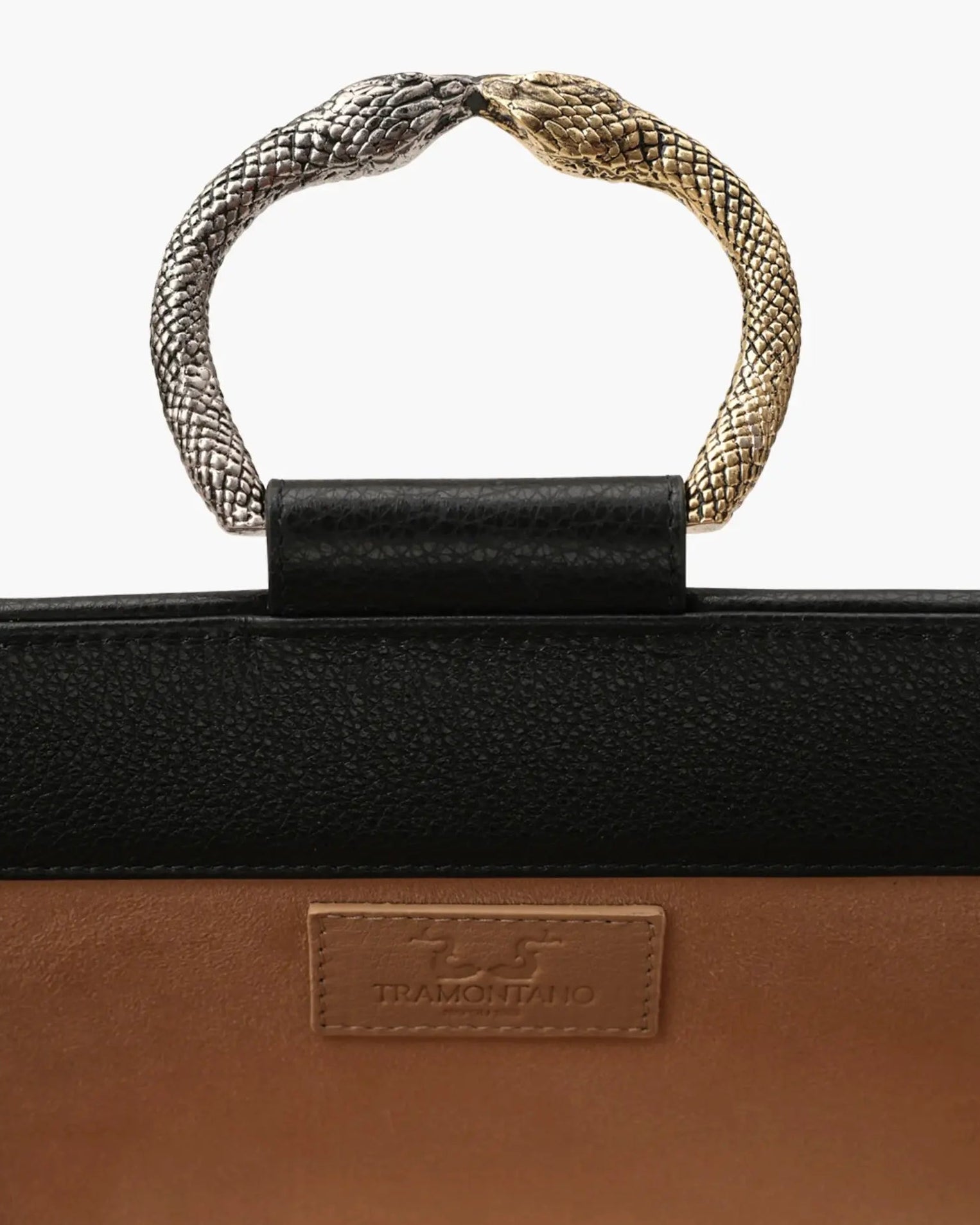 Laminated leather clutch with rounding rigid body and removable leather strail strap.Brass double-sided braceletDouble gold and silver color, iconic accessory of the Tramontano archive handcrafted. Top closure with double magnets. Microfiber lining. Accessories in silver finish. Material: shimmer calfDimensions: 31x12x8 cm
